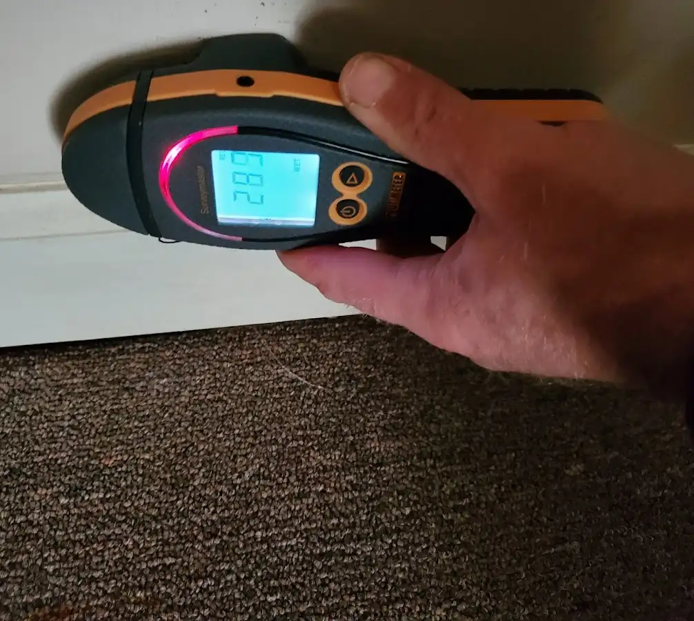 Moisture detection at baseboard during Storm Damage Restoration in West Milford